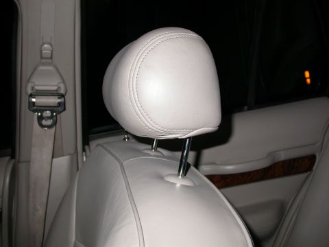 1998 Mercury Grand Marquis - Close-up view of a car's interior, focusing on a headrest and seatbelt. The registry claims it's a 1998 Mercury Grand Marquis, but this is…