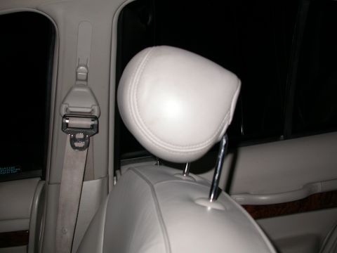 1998 Mercury Grand Marquis - Interior view of a 1998 Mercury Grand Marquis, focusing on the headrest and seatbelt assembly.