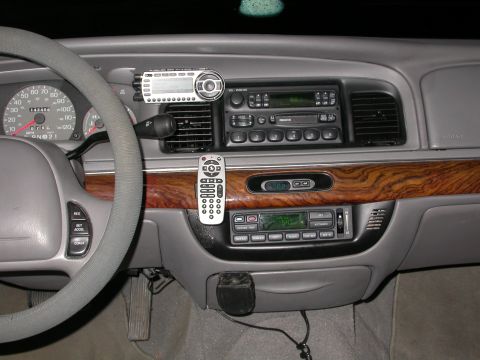 1998 Mercury Grand Marquis - Interior view of a 1998 Mercury Grand Marquis dashboard, an aftermarket stereo system and remote.