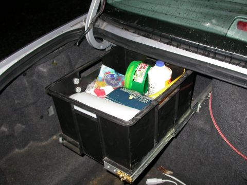 1998 Mercury Grand Marquis - Trunk organizer filled with cleaning products and other items, pulled out from its storage position.