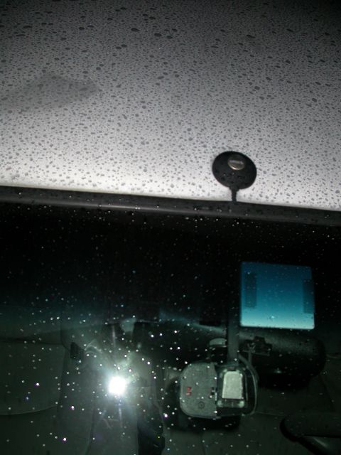 1998 Mercury Grand Marquis - Raindrops on the windshield obscure the view of the car's interior and dashcam.