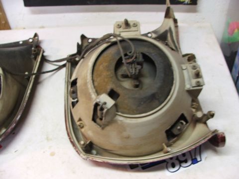 1965 Ford Mustang - Close-up of a car headlight assembly, showing internal components and wiring.