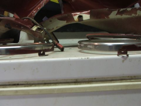 1965 Ford Mustang - Close-up of detached car body panels and chrome trim pieces, showing signs of wear and tear.