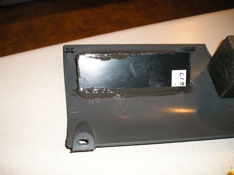 1993 Ford Bronco - A close-up view of a vehicle's dashboard trim panel, showing an opening prepared for a gauge installation.