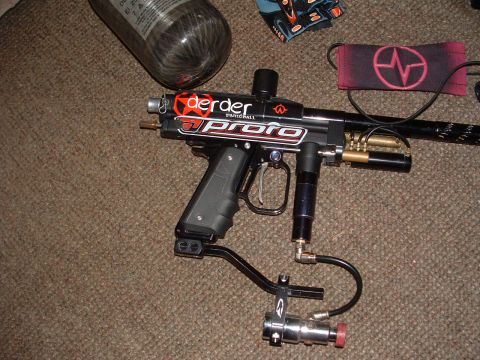 1984 Ford Bronco - Proto paintball gun and air tank are laid out on a carpeted surface.