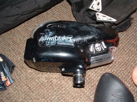 1984 Ford Bronco - A black paintball loader with visible text and logos is shown on a carpeted surface.