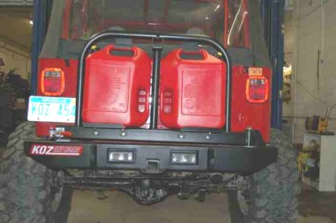 1994 Ford Bronco - This red Jeep features a rear-mounted swing-away carrier holding two red jerrycans and a KOZ Offroad bumper.