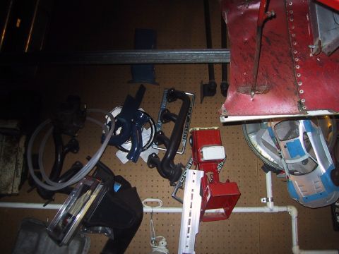 1994 Ford Bronco - A collection of automotive parts and a toy car are displayed on a pegboard wall.
