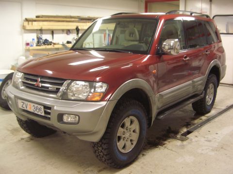 1996 Ford Bronco - Mitsubishi Pajero SUV with distinctive two-tone body panels and roof rack.
