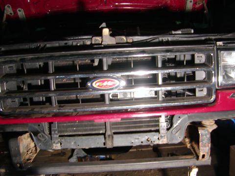 1991 Ford Bronco - Front view of a red 1991 Ford Bronco, showing the grille and F-M-C emblem.