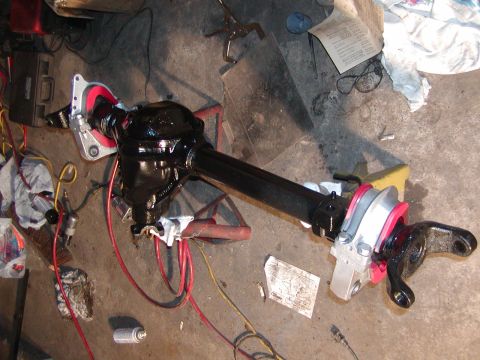 1991 Ford Bronco - A refurbished Ford Bronco Dana 44 front axle assembly rests on a garage floor, ready for installation.