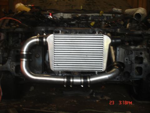 1994 Ford Probe - Close-up of an intercooler and piping system within a vehicle's engine compartment.