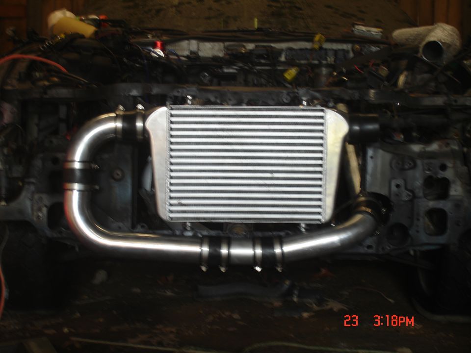 Intercooler and aluminum piping installed in a vehicle engine bay