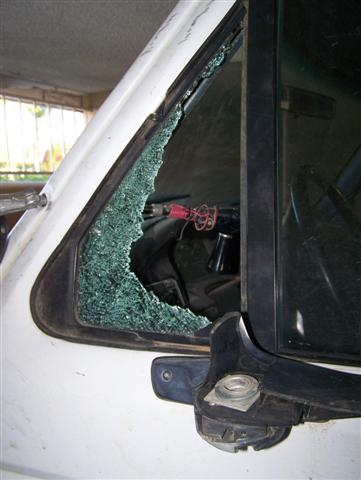 1995 Ford Bronco - The driver's side window of a 1995 Ford Bronco is broken, revealing the interior.
