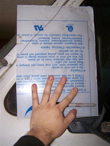 1995 Ford Bronco - A document with cleaning instructions is held by a hand, obscuring part of the text.