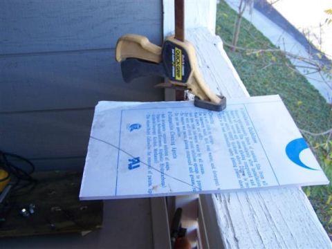 1995 Ford Bronco - A document with instructions is clamped to a white railing, with a portion of a blue graphic visible.