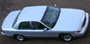 1998 Mercury Grand Marquis - A silver 1998 Mercury Grand Marquis sedan is captured from above, revealing its side profile and rear quarter.
