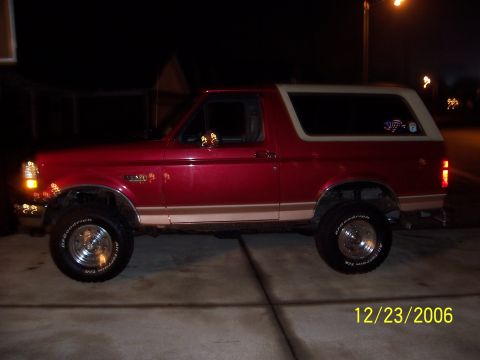 1994 Ford Bronco - This 1994 Ford Bronco features a two-tone red and tan paint scheme and appears to have a body lift.