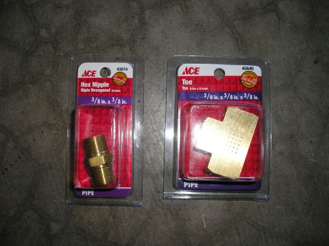 1993 Ford Bronco - Two plumbing fittings, a hex nipple and a tee, are packaged for retail sale.