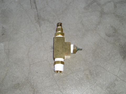 1993 Ford Bronco - Brass plumbing fitting with threaded connections on a concrete surface.