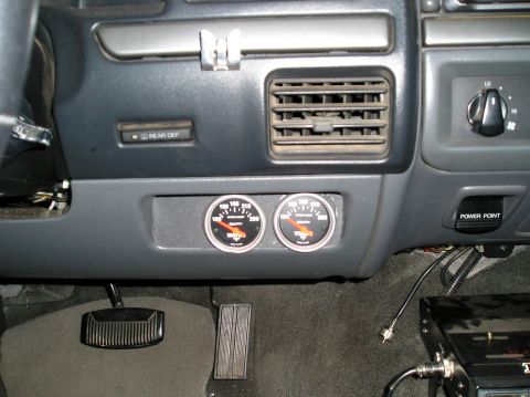 1993 Ford Bronco - Aftermarket gauges are installed in the dash of this vehicle's interior.