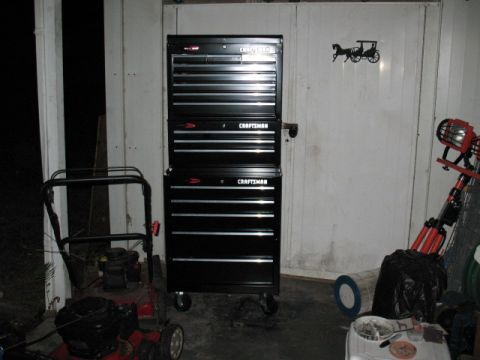 1997 Ford Crown Victoria - Garage scene with a stacked tool chest and a lawn mower, plus other items.