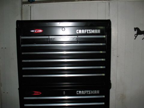1997 Ford Crown Victoria - A black Craftsman tool chest is shown against a white wall with a horse silhouette on the right.