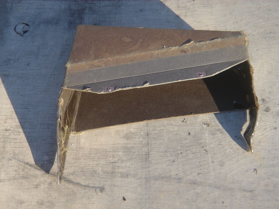 Brown upholstered interior trim piece viewed from another angle on concrete