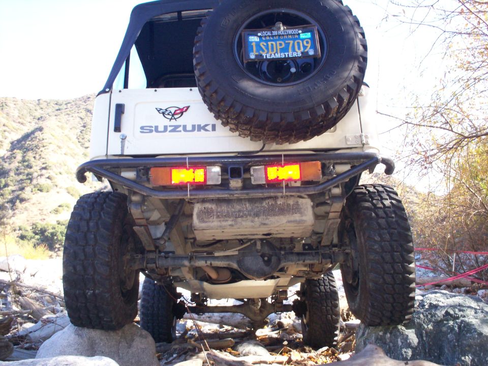 White 1987 Suzuki Samurai rear view with spare tire and California license plate
