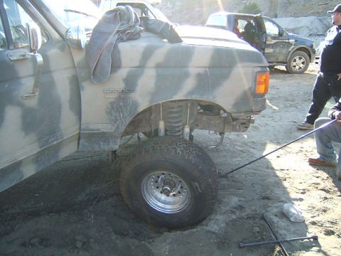 1988 Ford Bronco - A camouflaged 1988 Ford Bronco is shown with a lifted suspension and large off-road tires, with another truck visible in the background.