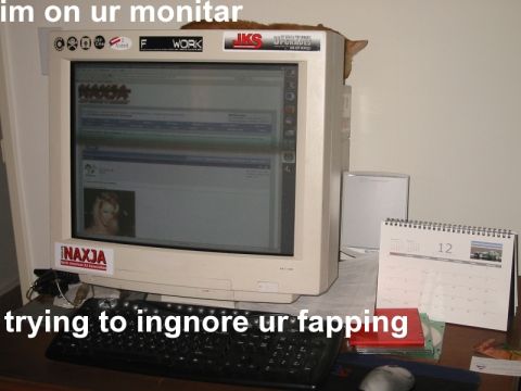 2000 Jeep Cherokee - A cat is perched on top of a computer monitor, with a keyboard and calendar visible on the desk.