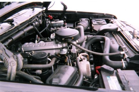 1996 Ford Bronco - The engine bay of a 1996 Ford Bronco shows its V8 engine and associated components.