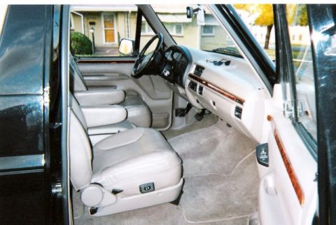 1996 Ford Bronco - The interior of a 1996 Ford Bronco, tan upholstery and wood trim accents.