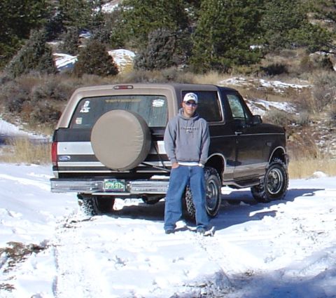1996 Ford Bronco - A man poses with his Ford Bronco, which is parked in a snowy, outdoor setting.