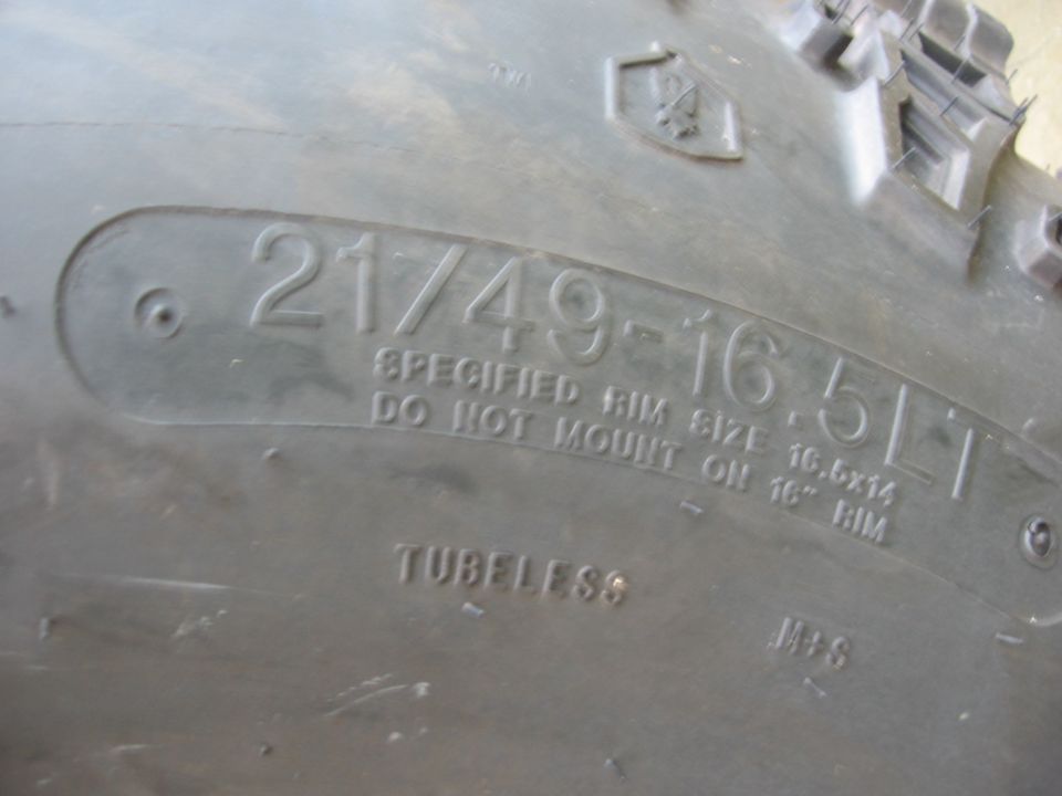 Tire sidewall with text 21/49-16.5LT, SPECIFIED RIM SIZE 16.5x14, DO NOT MOUNT ON 16" RIM, TUBLESS, M+S