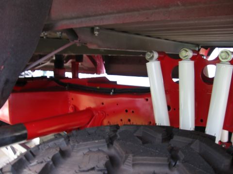 1974 Ford F-100 - Underside view of a truck's suspension system, showing the frame and shock absorbers.