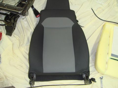 1996 Ford Bronco - A disassembled car seat is shown, with its internal frame and foam padding separated from the main seat cushion.