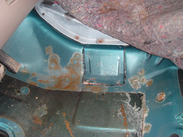 Interior rear cargo area with rust and carpet padding