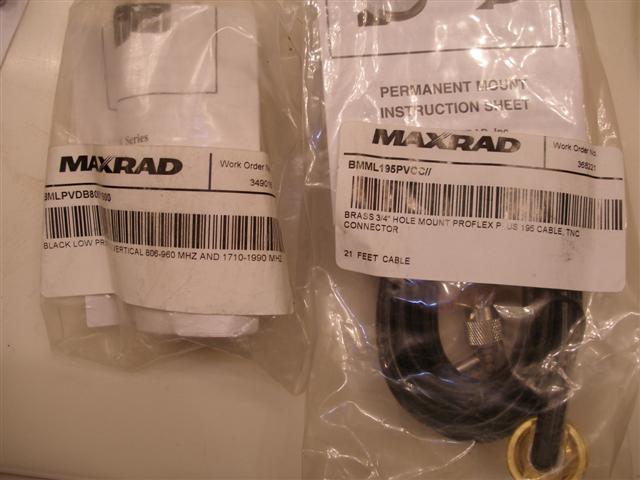 Two packaged Maxrad antenna parts: a black low-profile antenna and a brass hole mount with coiled cable