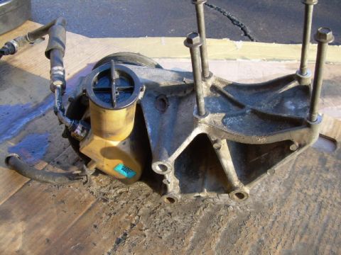 1992 Ford Bronco - This power steering pump assembly is shown removed from a vehicle, resting on a wooden surface.