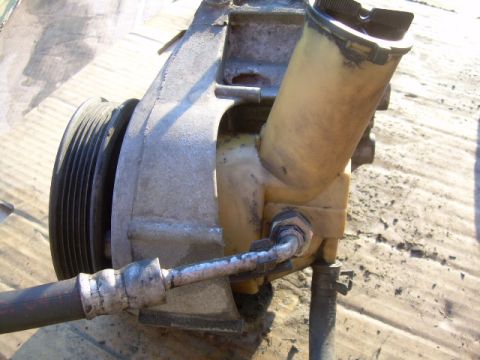 1992 Ford Bronco - A power steering pump assembly, including the pulley and reservoir, is shown in this close-up view.