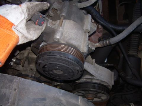 1992 Ford Bronco - Close-up view of a vehicle's power steering pump assembly, showing the pulley and belt system.