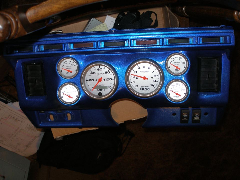 Blue custom dashboard with multiple gauges and vents