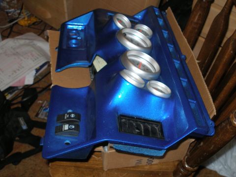 1984 Ford Bronco - A blue custom dashboard part with multiple gauges and switches is shown.