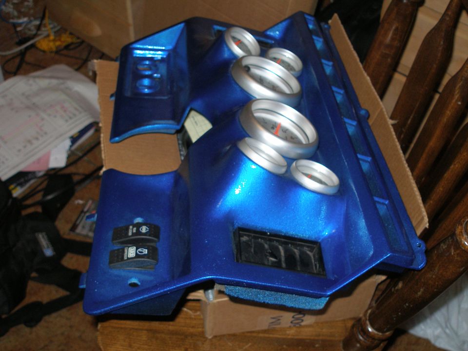 Blue custom dashboard piece with gauges and switches