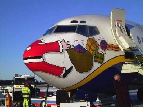 1968 Ford Mustang - An airplane is decorated with a festive painting of Santa Claus carrying a sack of gifts on its nose.