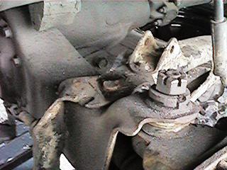1986 Ford Bronco - Detail of vehicle suspension components, including a large nut and bolt, with a SuperMotors watermark.