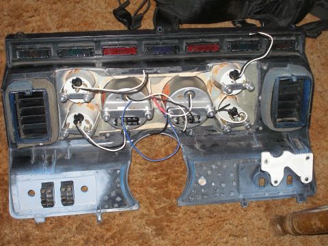 1984 Ford Bronco - This dashboard instrument cluster is shown with its internal components and wiring exposed.