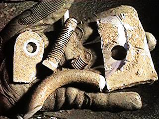 1986 Ford Bronco - Close-up of rusted metal parts and a bolt held in a gloved hand, with SuperMotors.net logo visible.