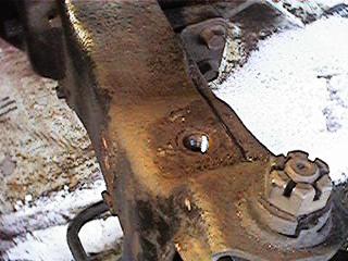 1986 Ford Bronco - A close-up view of a vehicle's suspension system, showing a heavily used and dirty component.